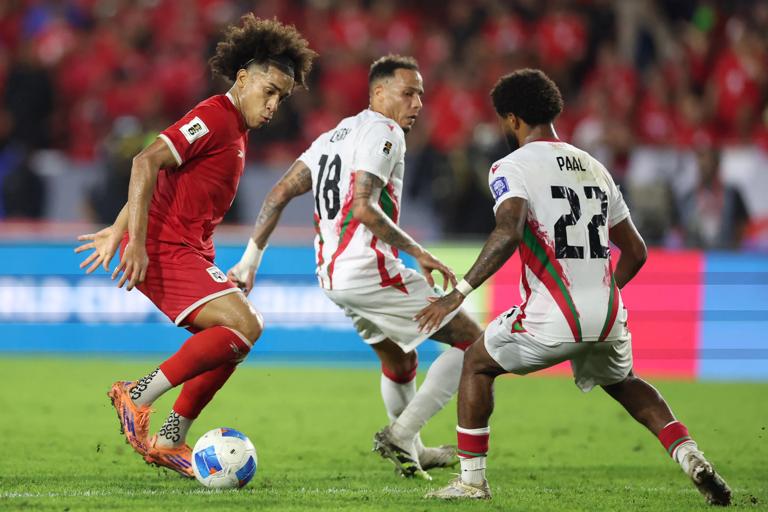 Panama's midfielder #08 Adalberto Carrasquilla and Suriname's defender #22 Kenneth Paal fight for the ball during the 2026 FIFA World Cup Concacaf qualifier football match between Panama and Suriname at the Rommel Fernandez Gutierrez Stadium in Panama City on October 14, 2025. (Photo by ARIS MARTINEZ / AFP) (Photo by ARIS MARTINEZ/AFP via Getty Images)          