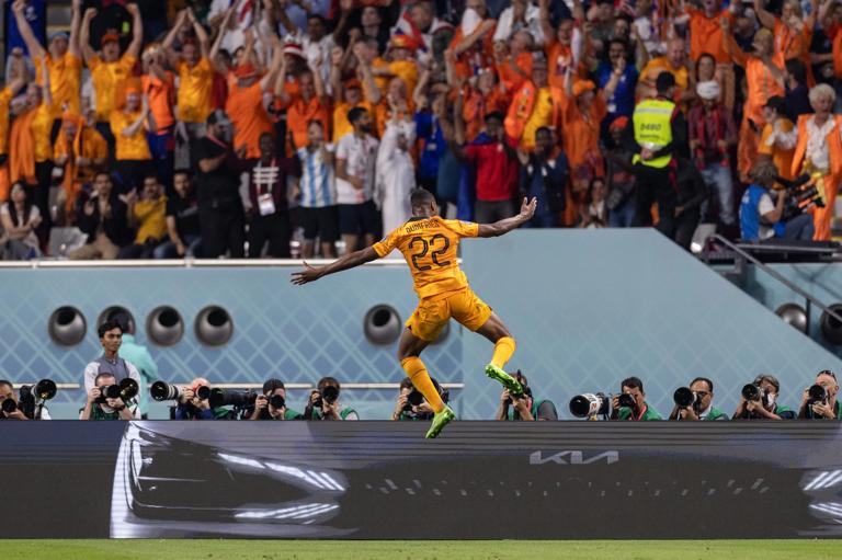 DOHA, QATAR - DECEMBER 03: Denzel Dumfries of The Netherlands celebrates scoring a goal during the FIFA World Cup Qatar 2022 Round of 16 match between Netherlands (3) and USA (1) at Khalifa International Stadium on December 03, 2022 in Doha, Qatar. (Photo by Simon Bruty/Anychance/Getty Images)